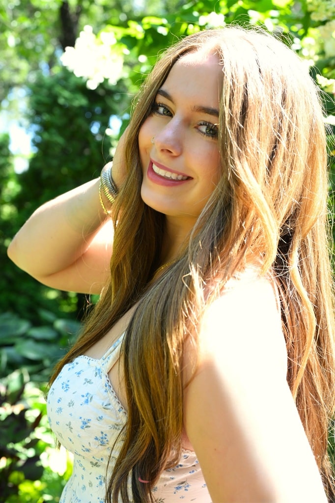 Senior photo of girl in white dress with big smile Close up of girl - Senior Photo over the shoulder, big smile