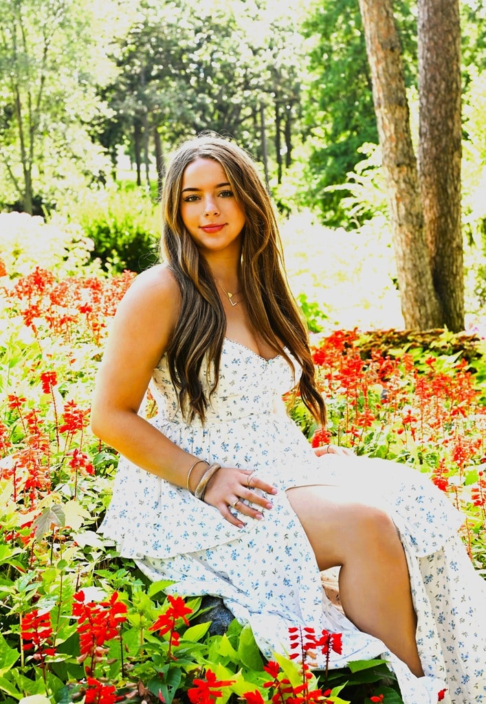 Senior Photo of girl in white dress at the flower garden Senior Photo of girl in white dress with flowers in the background